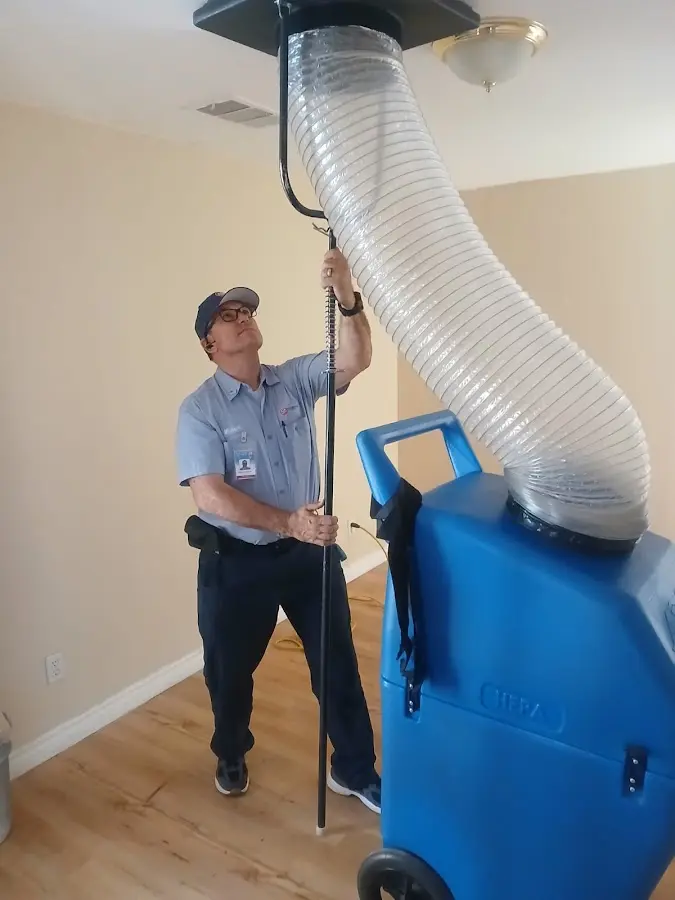 Furnace Tune-Up technician using HEPA equipment in Naples
